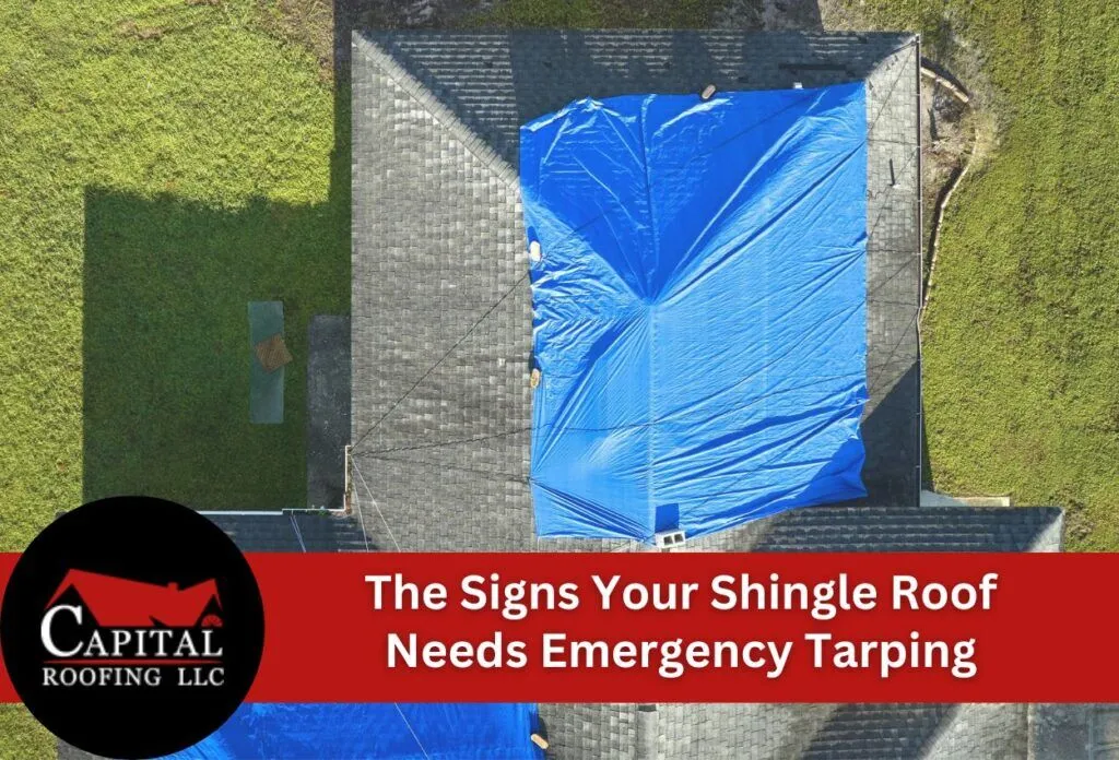 Aerial view of damaged roof covered with blue emergency tarp for protection