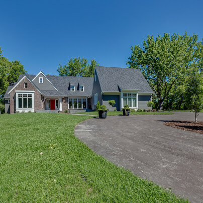 Charming suburban house with large yard and trees on a sunny day
