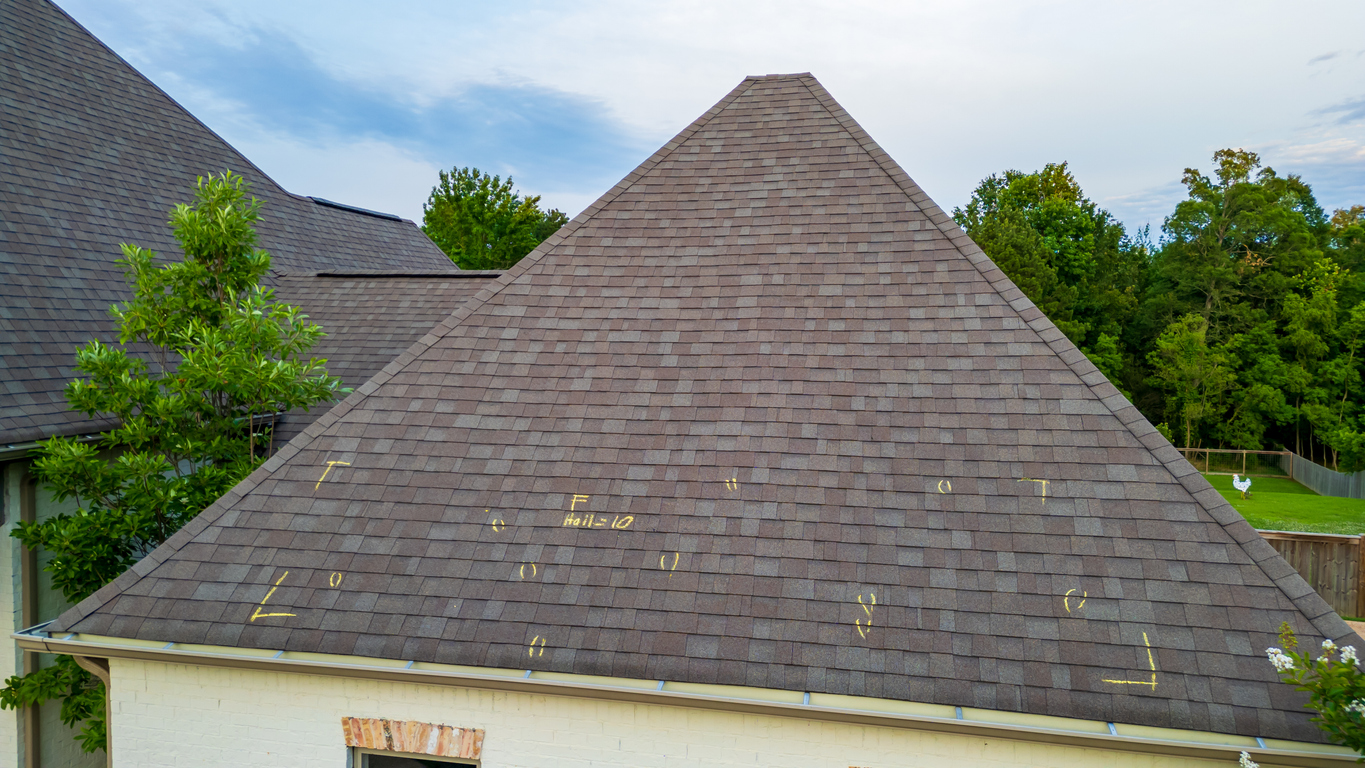 Aerial view of a roof with hail damage markings in chalk